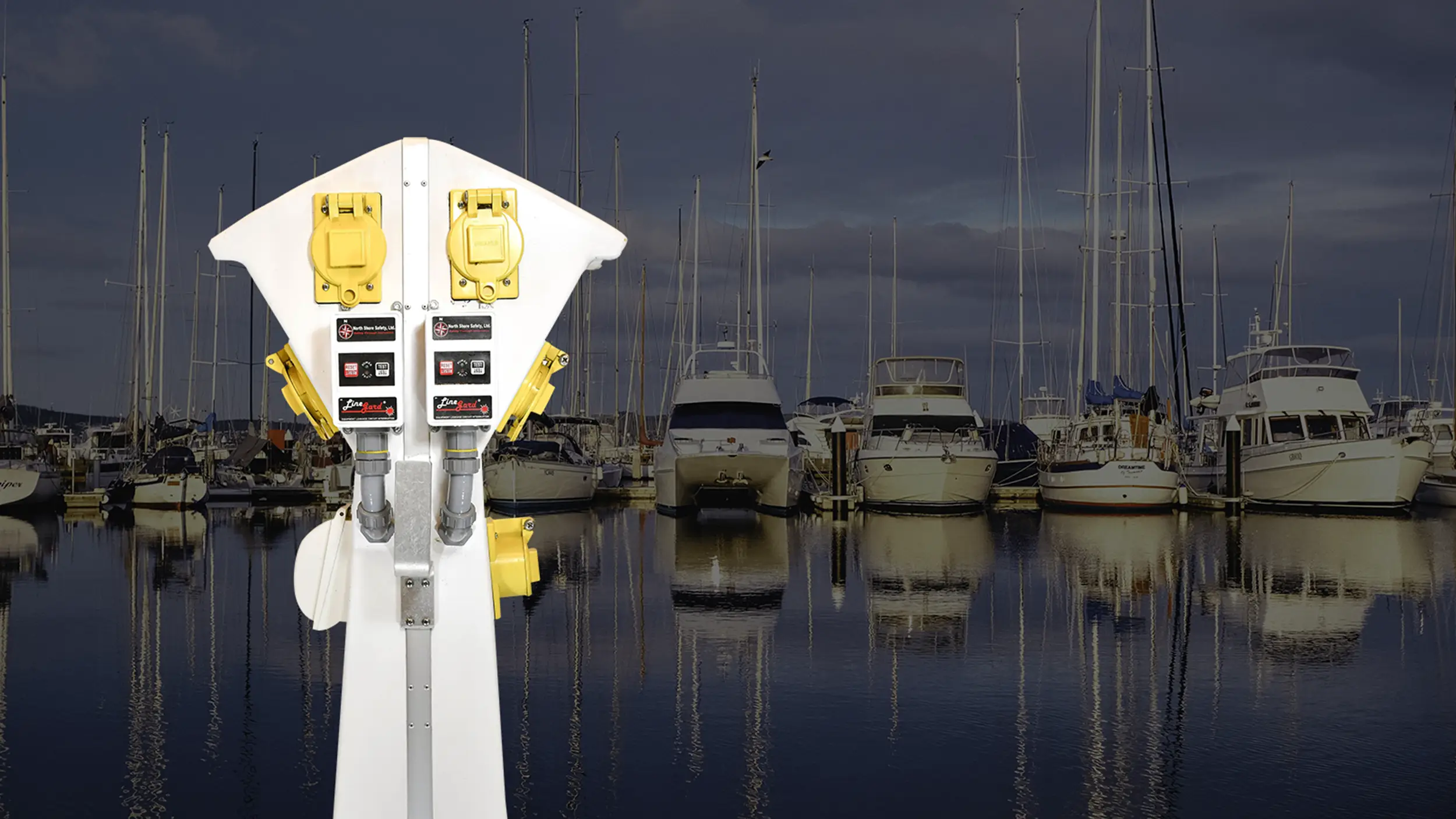 image of a marine pedestal equipped with North Shore Safety 30A ELCI in front of a marina
